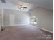 Large bedroom with neutral carpet and gray walls features a ceiling fan and natural light at 3304 Taviston Dr, Waxhaw, NC 28173