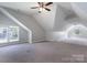 Spacious bonus room with neutral carpet, modern ceiling fan, and windows overlooking the community at 3304 Taviston Dr, Waxhaw, NC 28173