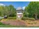 Attractive neighborhood entrance with stone signage and lush landscaping on a sunny day at 3304 Taviston Dr, Waxhaw, NC 28173