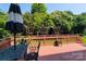 Inviting outdoor deck with a cast aluminum table set for backyard entertaining, framed by a lush treeline at 3304 Taviston Dr, Waxhaw, NC 28173