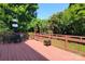 Expansive outdoor deck with seating and a trellised fence and garden at 3304 Taviston Dr, Waxhaw, NC 28173