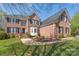Traditional brick home with lush landscaping, dark shutters and manicured lawn at 3304 Taviston Dr, Waxhaw, NC 28173