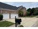 Charming brick home featuring an attached two-car garage and a well-manicured front yard at 3304 Taviston Dr, Waxhaw, NC 28173