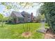 Lush backyard showcasing a well-maintained lawn, mature trees, and a lovely patio at 3304 Taviston Dr, Waxhaw, NC 28173