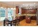 An eat-in kitchen showcases cherry cabinets, granite counters, stainless appliances, and beautiful natural light at 3304 Taviston Dr, Waxhaw, NC 28173