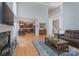 Bright open-concept living room featuring hardwood floors and fireplace with views to the kitchen at 3304 Taviston Dr, Waxhaw, NC 28173