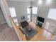 Overhead view of a sunlit living room featuring a cozy fireplace and tall windows at 3304 Taviston Dr, Waxhaw, NC 28173