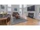Bright living room with a cozy fireplace, plush couches, and large windows for natural light at 3304 Taviston Dr, Waxhaw, NC 28173