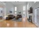 Bright living room features soaring ceilings, large windows, fireplace, and gleaming hardwood floors at 3304 Taviston Dr, Waxhaw, NC 28173