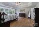 Serene main bedroom with hardwood floors and large windows overlooking the backyard at 3304 Taviston Dr, Waxhaw, NC 28173