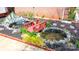 Charming backyard pond with a small bridge, surrounded by colorful plants and flowers at 3304 Taviston Dr, Waxhaw, NC 28173