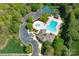 Aerial view of community pool, clubhouse, and tennis courts surrounded by lush greenery at 3304 Taviston Dr, Waxhaw, NC 28173