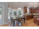 Charming eat-in kitchen with wooden cabinetry, granite counters and large windows at 3304 Taviston Dr, Waxhaw, NC 28173