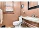 Cozy half bathroom featuring a modern vanity, toilet, and decorative mirror at 335 Deep Forest Ct, Gastonia, NC 28056