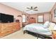 Comfortable bedroom with ceiling fan, windows, and light pink painted walls at 335 Deep Forest Ct, Gastonia, NC 28056