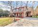 Two story home featuring a covered front porch and long driveway situated on a large yard at 335 Deep Forest Ct, Gastonia, NC 28056