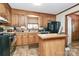 Charming kitchen with wood cabinets, stainless steel appliances, and a functional island at 335 Deep Forest Ct, Gastonia, NC 28056