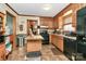 This kitchen features classic wood cabinetry, modern black appliances and butcher block island at 335 Deep Forest Ct, Gastonia, NC 28056