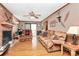 Inviting living room with brick fireplace, wood floors, and comfortable seating at 335 Deep Forest Ct, Gastonia, NC 28056