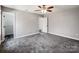Large bedroom with gray walls, ceiling fan, and two closets at 350 Belvedere Nw Dr, Concord, NC 28027
