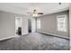 Spacious bedroom with ceiling fan, carpet flooring, and two closets at 350 Belvedere Nw Dr, Concord, NC 28027