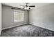 Bedroom with ceiling fan, large window, and plush carpeting at 350 Belvedere Nw Dr, Concord, NC 28027