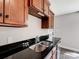 Close-up of the kitchen sink and countertop with wood cabinets and natural lighting at 350 Belvedere Nw Dr, Concord, NC 28027