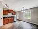 Well-lit kitchen with stainless steel appliances, wood cabinets, and a door leading outside at 350 Belvedere Nw Dr, Concord, NC 28027