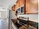 Modern kitchen features stainless steel appliances, dark countertops, and wood cabinetry at 350 Belvedere Nw Dr, Concord, NC 28027