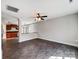 Open living area with dark wood-look flooring, ceiling fan, and plenty of natural light at 350 Belvedere Nw Dr, Concord, NC 28027