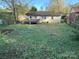 This expansive backyard has a weathered wooden deck and a grassy area, perfect for outdoor gatherings at 3915 Crestridge Dr, Charlotte, NC 28217