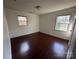 This bedroom offers hardwood flooring, neutral walls, and a pair of windows that bring in natural light at 3915 Crestridge Dr, Charlotte, NC 28217