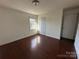 Comfortable bedroom showcasing natural light, hardwood floors, and closet at 3915 Crestridge Dr, Charlotte, NC 28217