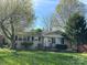 Charming single-story home featuring a well-maintained lawn and a classic brick facade at 3915 Crestridge Dr, Charlotte, NC 28217