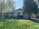 Charming single-story home with classic curb appeal, lush landscaping, and a well-maintained lawn at 3915 Crestridge Dr, Charlotte, NC 28217