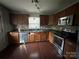 Well-equipped kitchen features stainless appliances, granite countertops, and mosaic backsplash at 3915 Crestridge Dr, Charlotte, NC 28217