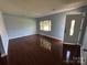 Well-lit living room with hardwood floors, bay window, and a bright front door at 3915 Crestridge Dr, Charlotte, NC 28217