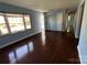 Inviting living room featuring hardwood floors, natural light and an open doorway at 3915 Crestridge Dr, Charlotte, NC 28217