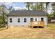 Exterior back of home featuring a wood deck and light gray siding at 409 Bost St, Kannapolis, NC 28081