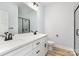 Bathroom with double sink vanity, quartz countertop, black hardware, and walk-in shower at 409 Bost St, Kannapolis, NC 28081