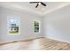 Bedroom featuring tray ceilings, two windows allowing for great natural light with wood-look floors at 409 Bost St, Kannapolis, NC 28081