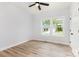 Bedroom with wood-look flooring, modern ceiling fan, and large windows overlooking the yard at 409 Bost St, Kannapolis, NC 28081