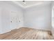 Light-filled bedroom featuring wood-look floors, modern ceiling fan, and two closets with white doors at 409 Bost St, Kannapolis, NC 28081