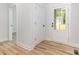 Bright entryway features wood flooring, a coat closet, and a glass-paneled front door at 409 Bost St, Kannapolis, NC 28081