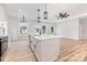 Bright kitchen boasts a white island, stainless steel appliances, and wood flooring at 409 Bost St, Kannapolis, NC 28081