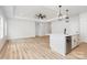 Spacious living room featuring wood flooring, recessed lighting, and an island with bar seating at 409 Bost St, Kannapolis, NC 28081