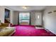 Cozy living room with bright carpet and a large window overlooking the outdoors at 455 Pinhook Loop Rd, Gastonia, NC 28056