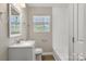 Updated bathroom with a bright vanity, framed mirror, and shower with white subway tile surround at 4931 Galax Dr, Charlotte, NC 28213