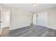 Neutral bedroom with gray wood floors, closet, and ample space at 4931 Galax Dr, Charlotte, NC 28213