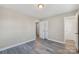 Comfortable bedroom with gray wood floors and a view into the hallway at 4931 Galax Dr, Charlotte, NC 28213